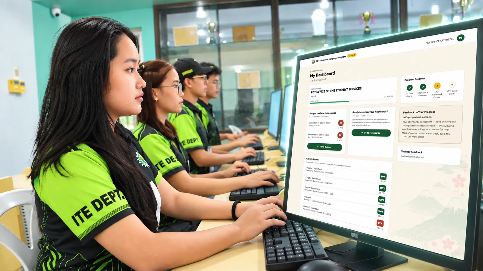 Students in green ITE Dept shirts working at computer lab desks, with a mockup of the Student Portal's My Dashboard screen — quiz scores, program progress, and flashcard access — shown on a monitor in the foreground
